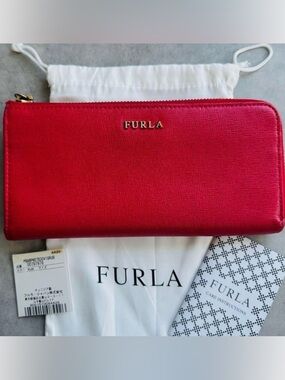 This item is a Furla Babylon XL Zip Around Wallet in red leather.